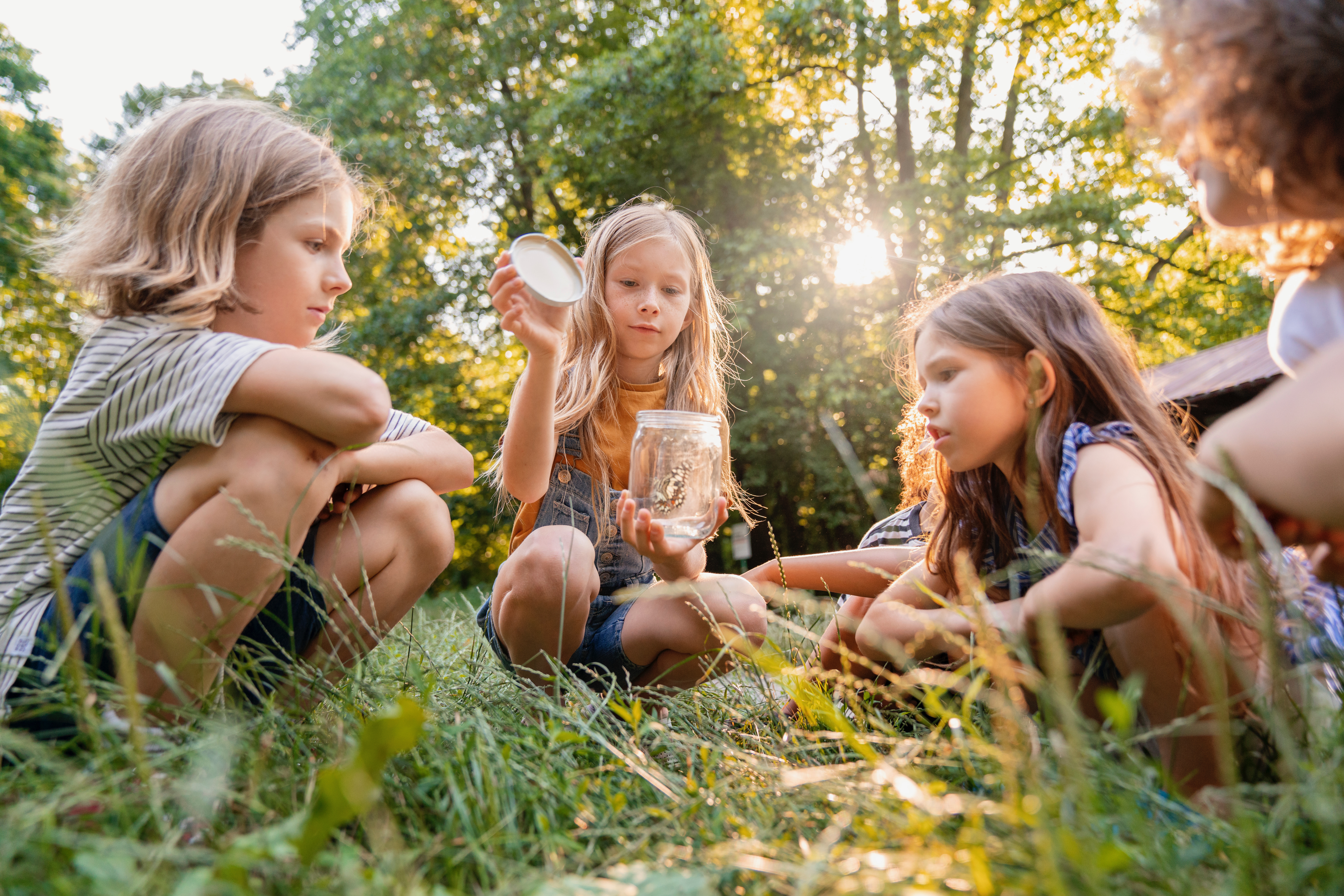 side-view-kids-sitting-grass